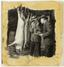 [Inspector talking to farmer beside the dead hogs hanging from meat hooks. June 11, 1945] [Kolada]
