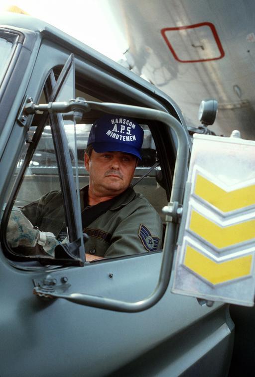 Air Force Reserve STAFF Sergeant Jack Riley backs a flush truck up to a ...