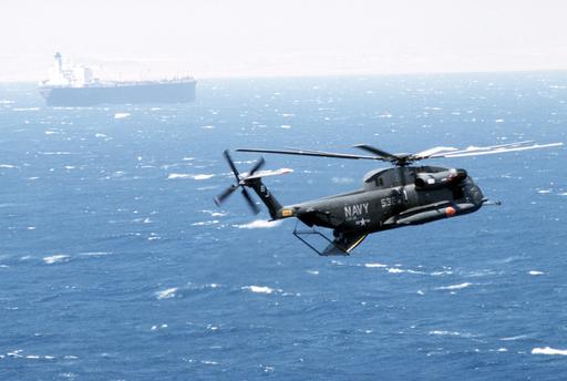 A right rear view of an RH-53D Sea Stallion helicopter in flight, in ...