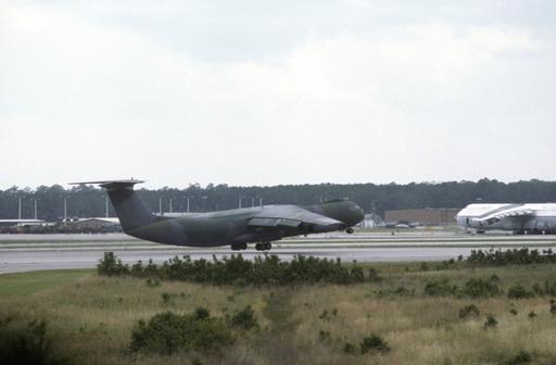 A C-141B Starlifter aircraft takes off during an air show — NARA and ...