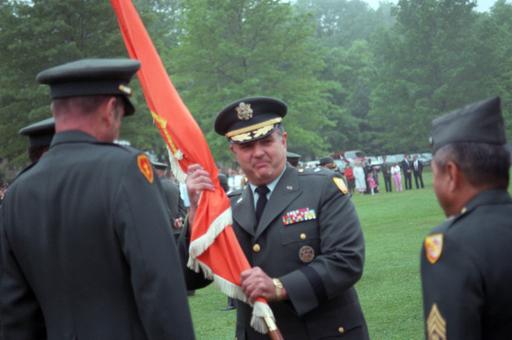 Brigadier General (BGEN) Eugene Renzi grasps a flag after assuming ...