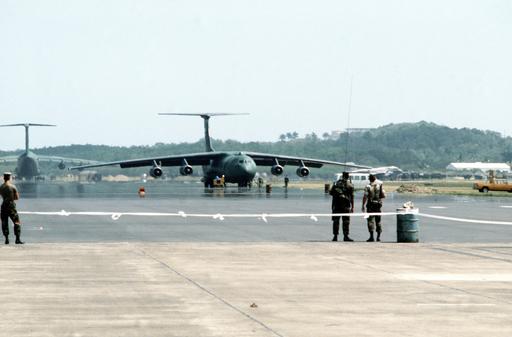 Two Air Force C-141B Starlifter aircraft sit on the ground at the ...