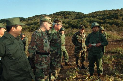Listening to a Japanese Self Defense Force officer are, from left to ...
