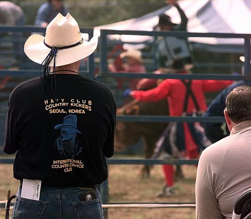 Spectators line the fences to watch the bull riding… — PICRYL - Public ...
