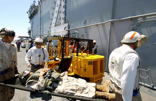 US Navy crew members from the Wasp Class Amphibious Assault Ship USS ...