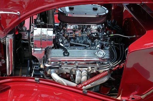 A red car with a chrome engine on display. Car engine motor engine ...