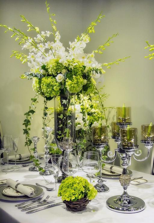 A table set for a formal dinner with flowers in a vase. Flower nice ...