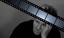 A black and white photo of a man holding a film strip. Head think slide strips.