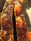A close up of a piece of food on a table. Soil honey the original ecology natural.