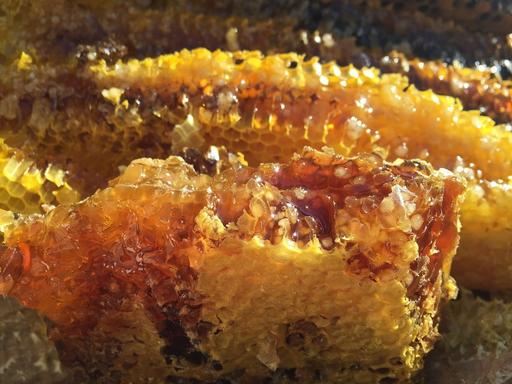 A close up of some food on a table. Soil honey the original ecology natural., soil, honey, ecology, natural, close up, dirt