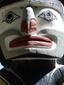 A close up of a statue of a face. Totem pole aboriginal art.