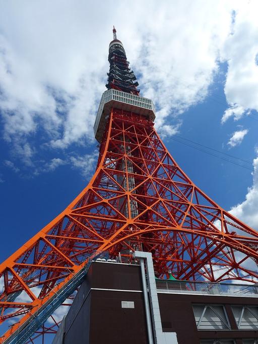 A tall red tower with a sky background. Tokyo tower… — PICRYL