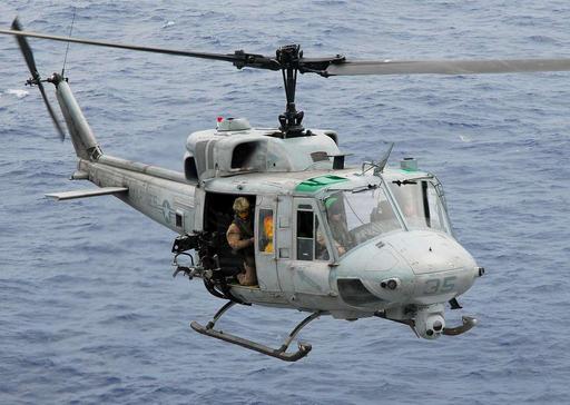 A UH-1N Twin Huey helicopter gunship approaches the flight