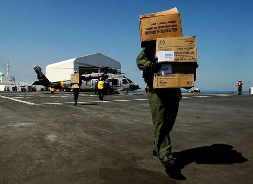 crewmen and flight deck personnel unload medical relief… — PICRYL ...
