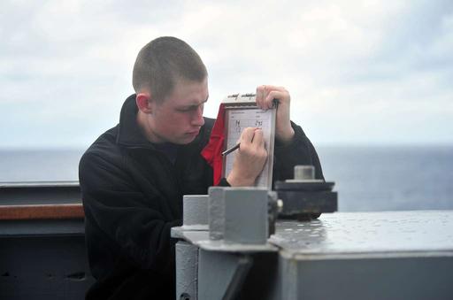 Personnel Specialist Seaman Julian Ramey records the ship's courses and ...