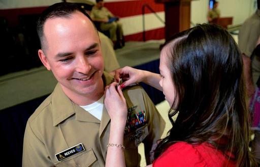Chief Warrant Officer Christopher Reeves receives his new collar device ...