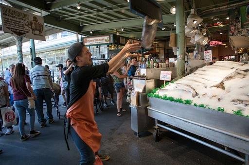 There's arguably nothing more original and entertaining than fish throwing there the Seattle Bloggers Web site has proclaimed. That's open to debate, but there's no doubt that the tosses of freshly caught fish to each other and even paying customers draws a big crowd at the city's public market, fish, throwing, pike place market, seattle, market, seafood, vendors, tourism, tourists