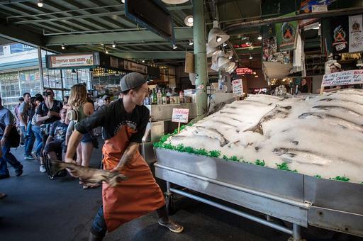 There's arguably nothing more original and entertaining than fish throwing there the Seattle Bloggers Web site has proclaimed. That's open to debate, but there's no doubt that the tosses of freshly caught fish to each other and even paying customers draws a big crowd at the city's public market, fish, throwing, pike place market, seattle, market, seafood, vendors, tourism, tourists