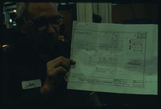 Jimmy Dowling holding the blueprint for a buncher part; the original machine was drawn and built in 1945, but Jimmy makes copies of parts that are used to repair Watson machines still in use that require the part to continue running., jimmy dowling, blueprint, buncher, machine, engineering, technology