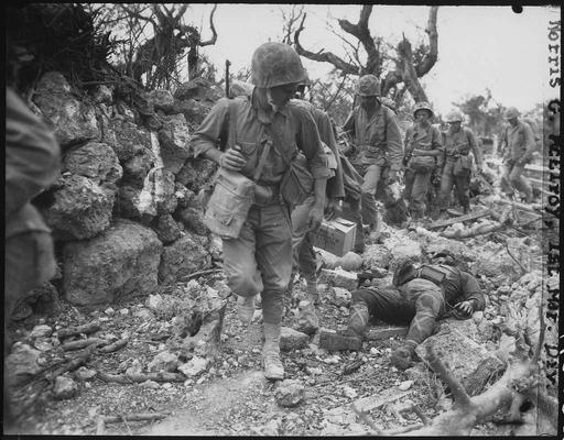 Marines pass through a small village where Japanese… — PICRYL