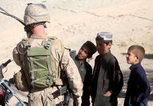 Afghan children watch as Capt. Ryan L. Bumgardner, - NARA & DVIDS ...