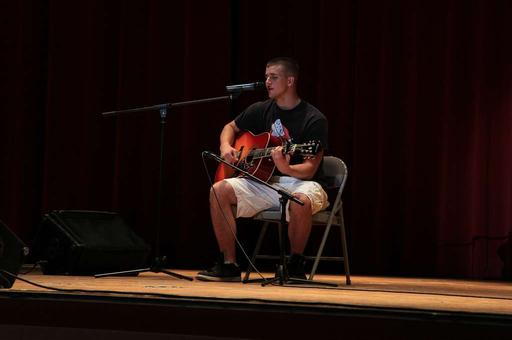 Andrew Burch sings and plays an original song on the, andrew burch, man, singing, acoustic guitar, song, music, performance