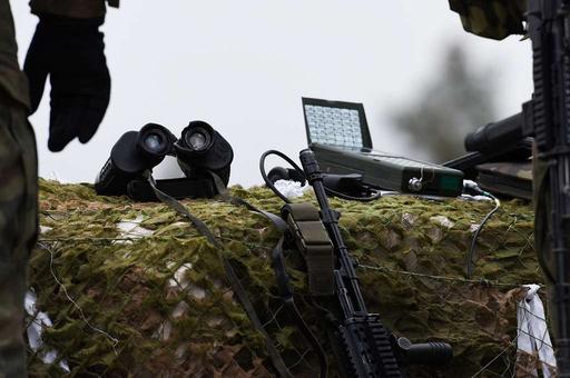 A forward observer stands back from his equipment waiting - NARA ...