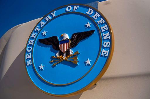 The Secretary of Defense seal is seen on a government - NARA & DVIDS ...