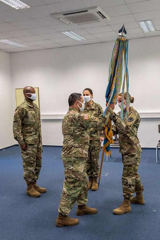 Army Lt. Col. Tracy Yates (right) passes the unit colors — NARA and ...