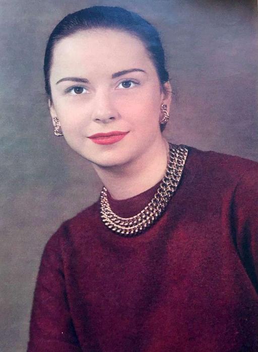 Joan Chandler 1948 - A woman in a red sweater posing for a
